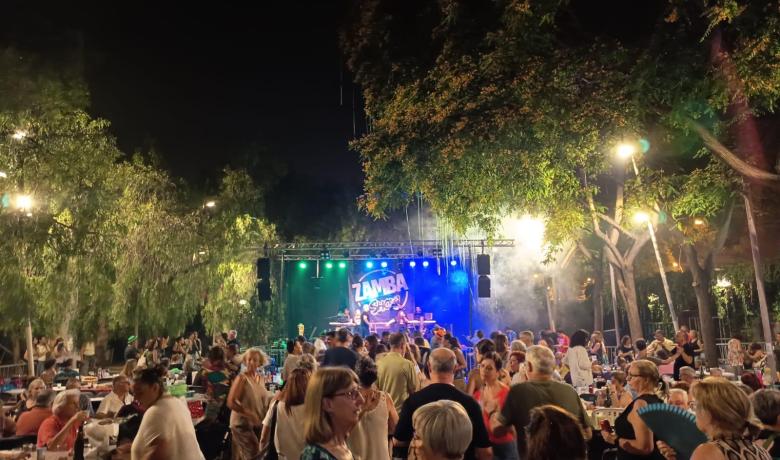 a la imatge es veu molta gent ballant i al fons, un escenari amb l'orquestra